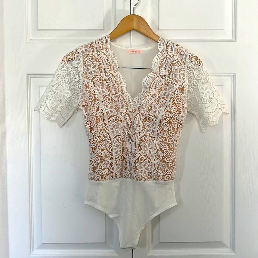 White and nude lace bodysuit.